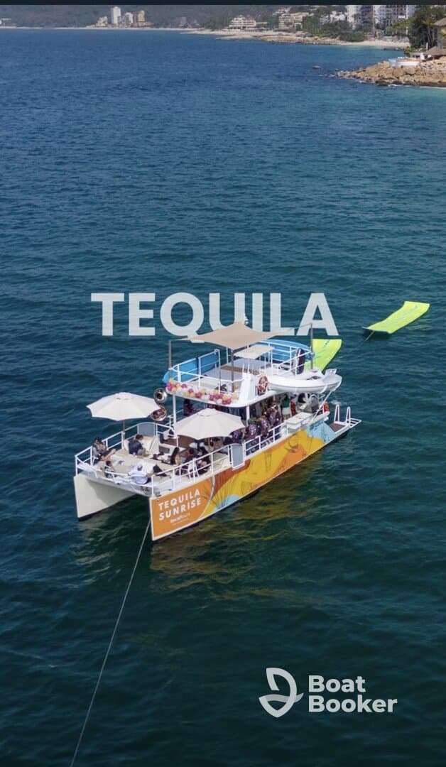 A vibrant party boat named 'Tequila Sunrise' is anchored in clear waters, with guests enjoying the sun and festivities — perfect for a lively day on the water.