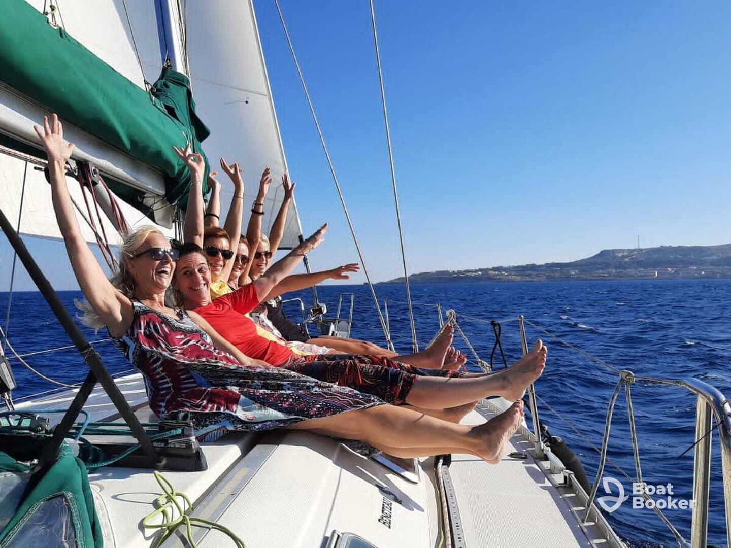 A joyful group of friends enjoys a sailing adventure, celebrating with laughter and fun on the deck — perfect for memorable outings on the water.