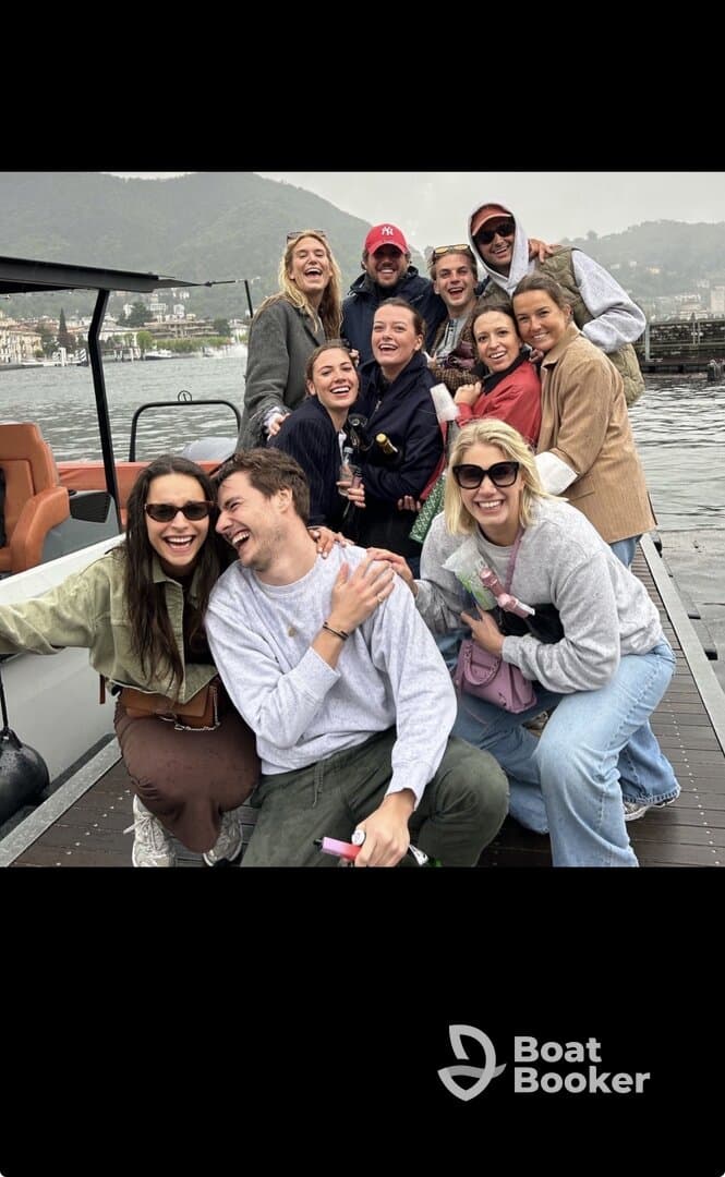 A lively group of friends enjoys a fun moment aboard a boat, capturing the joy of their outing together against a scenic backdrop.