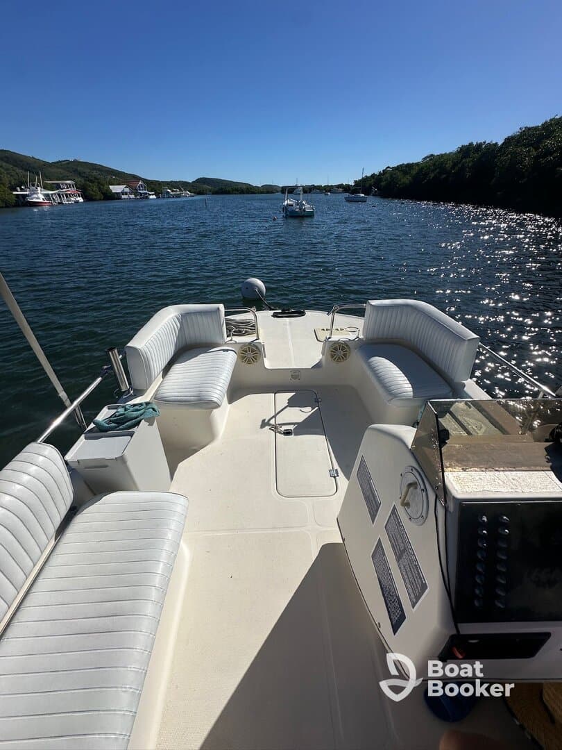 A well-appointed interior view of a boat's helm and seating area, showcasing comfortable seating and a clean layout, perfect for relaxing on the water.