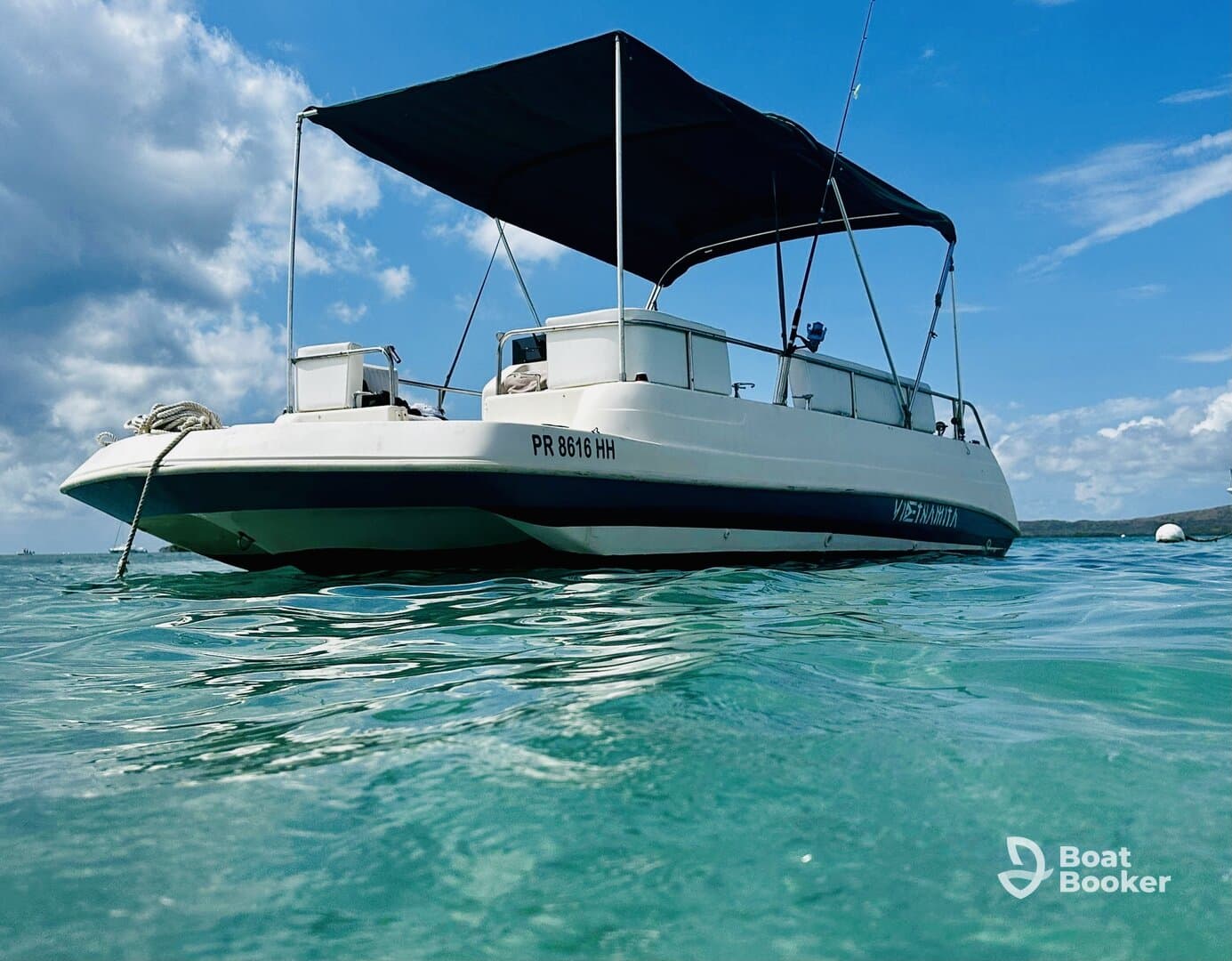 A sleek speedboat anchored in clear turquoise waters, perfect for a day of adventure on the sea.