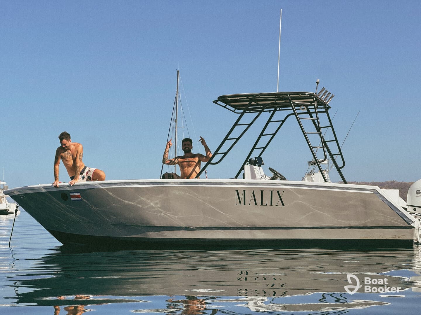 Two friends enjoy a sunny day on their boat, showcasing camaraderie and fun on the water — perfect for adventure seekers and boat enthusiasts.