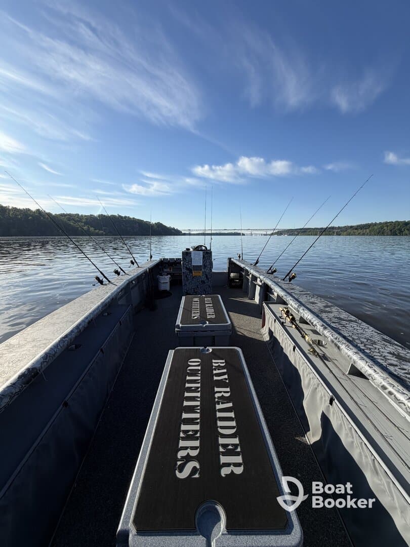 Interior view of a fishing boat equipped with seating and fishing gear, perfect for a day on the water with Bay Raider Outfitters.
