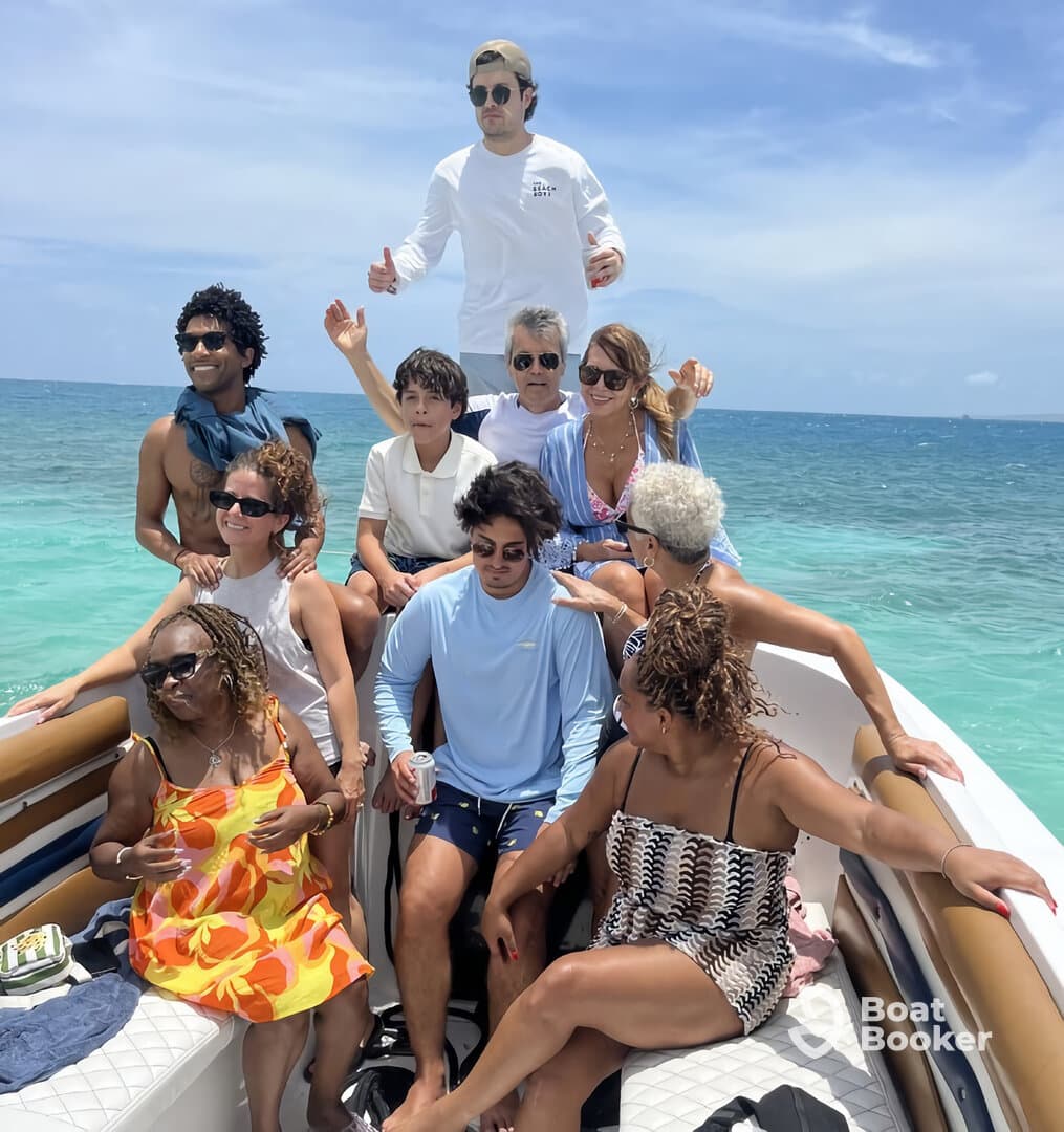 A lively group enjoys a fun day on the boat, showcasing the joy of togetherness and celebration under the sun.