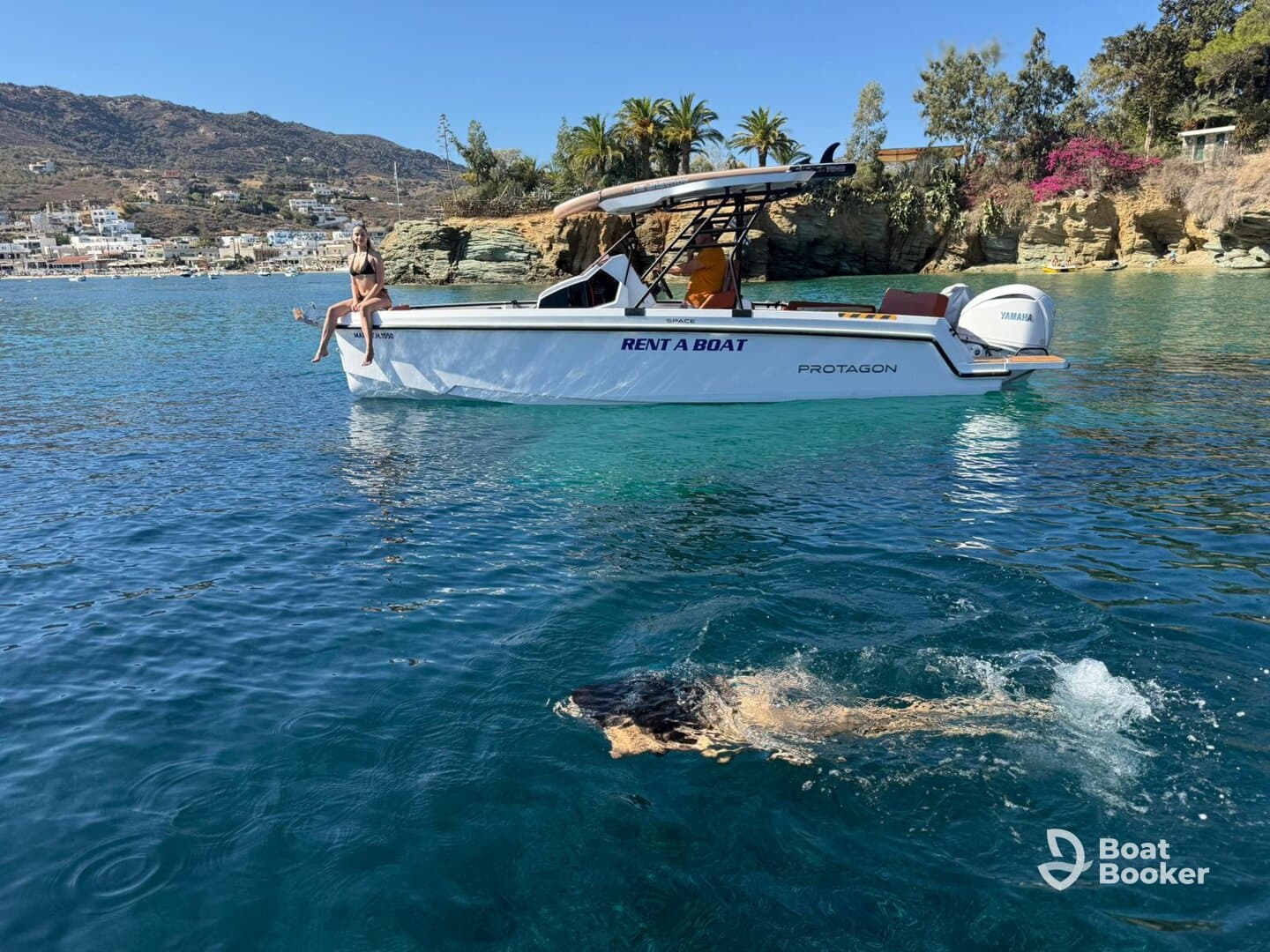 A person enjoys a sunny day by the boat, with a dog swimming nearby in crystal-clear waters — a perfect summer adventure on the water.