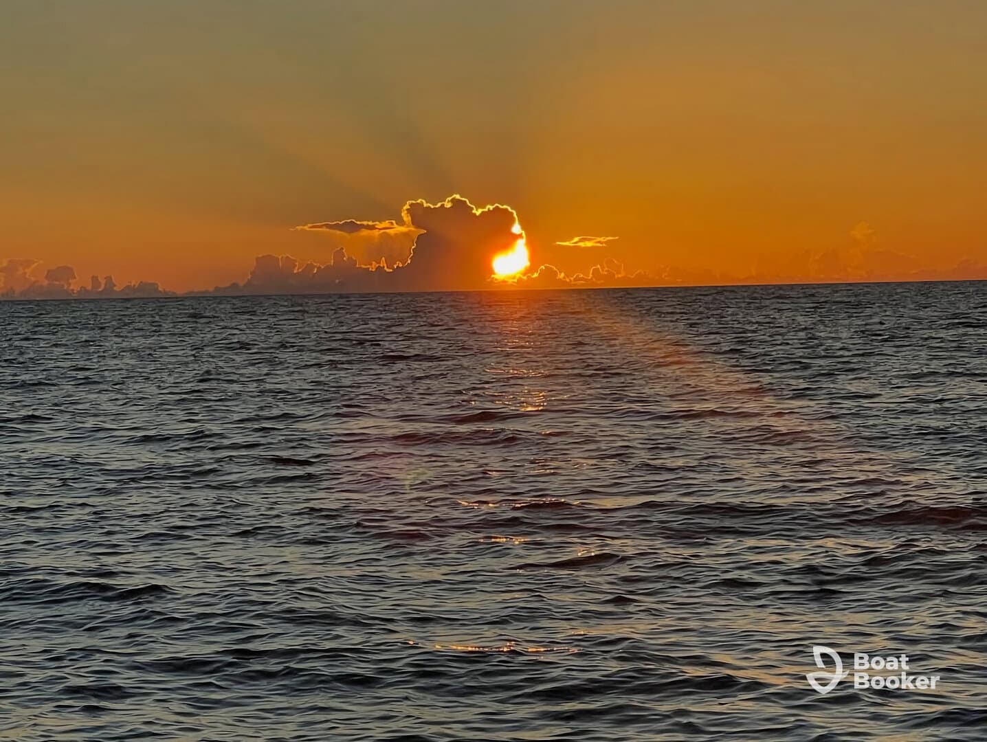 A stunning sunset over the ocean, casting vibrant colors across the sky and water — a perfect backdrop for evening boat trips and romantic getaways.