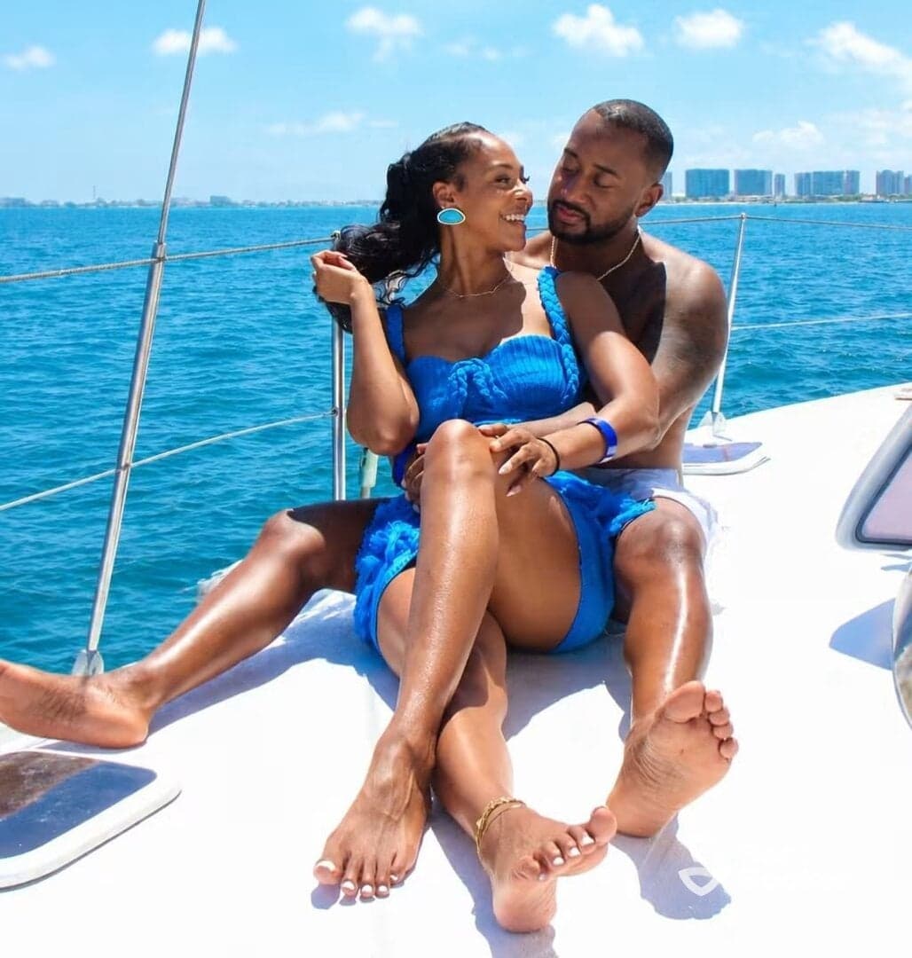 A couple enjoys a romantic moment on a yacht, basking in the sun and surrounded by beautiful blue waters — perfect for intimate getaways or special celebrations.