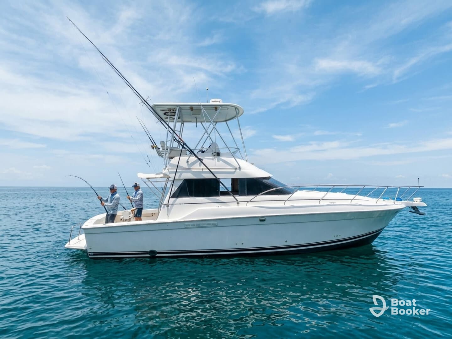 Two anglers enjoy a day of fishing on a sleek boat, surrounded by the tranquil ocean waters — a perfect scene for fishing enthusiasts.