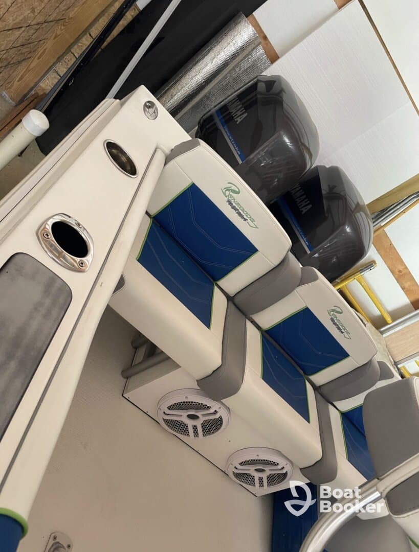 Interior view of a boat's seating area featuring stylish blue and gray upholstery, ideal for comfort while cruising on the water.