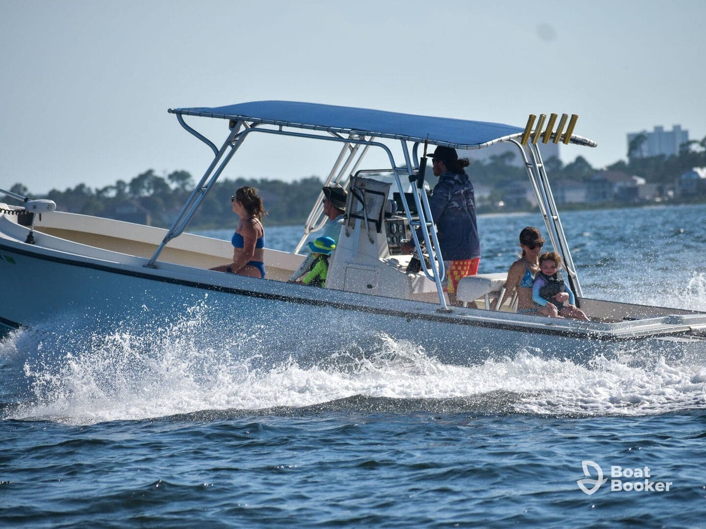 A joyful family enjoys a day on the water aboard a boat, with children and adults soaking up the sun and splashing through the waves.