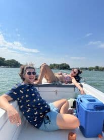 A fun summer day on the water with friends relaxing and sunbathing on a boat — perfect for creating unforgettable memories.