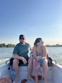 A couple enjoys a sunny day on a boat, capturing the essence of relaxation and adventure on the water.