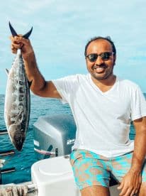 A proud angler displays his catch while enjoying a day out on the water — a perfect moment for fishing enthusiasts.