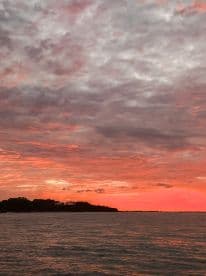 A breathtaking sunset paints the sky in vibrant hues over the water, creating a picturesque backdrop for evening boat trips and romantic getaways.
