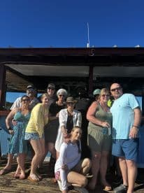 A cheerful group poses for a photo, capturing a memorable moment during their boating adventure. Perfect for showcasing fun times and celebrations on the water.