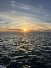 A stunning sunset over the ocean, capturing the serene beauty of the water and sky — perfect for tranquil evening boat rides.