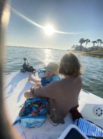 A mother and child enjoy a sunny day on a boat, creating cherished family memories on the water.