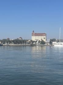 A view of a waterfront scene featuring a building and a yacht, but the image lacks clarity and detail.