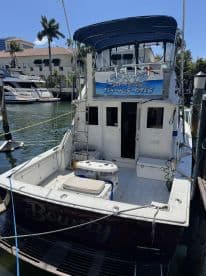 A clear view of the back of the 'Bowdy' boat docked, showcasing its structure and features, perfect for fishing trips in Fort Lauderdale.