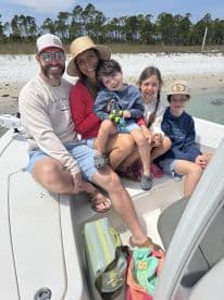 A joyful family enjoys a sunny day on their boat, creating lasting memories together. Perfect for family outings and adventures on the water.