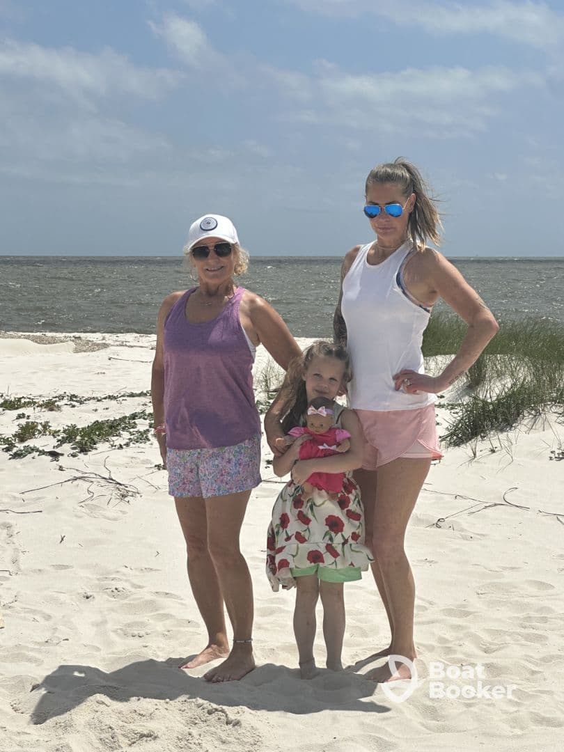 A joyful family poses together on the beach, capturing a memorable moment in the sun — perfect for family vacations and beach outings.