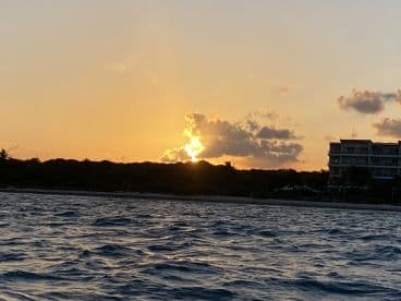 A stunning sunset over the coastline, capturing the serene beauty of the water and sky — perfect for romantic evening cruises or peaceful reflections.
