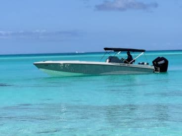 A sleek speedboat glides through crystal-clear turquoise waters, perfect for a day of adventure on the open sea.