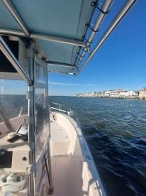 A view from the helm of a boat, showcasing the interior layout and dashboard, perfect for navigating the waters.