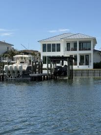 A scenic view of a boat docked at a waterfront property, showcasing the perfect blend of luxury living and boating lifestyle.