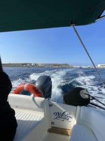 A view from the helm of a boat, showcasing the seating area and a 'Welcome aboard' sign, perfect for inviting guests to enjoy their time on the water.