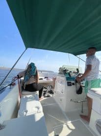 Inside view of a boat's helm area, featuring guests relaxing and enjoying the ride — perfect for a day on the water.