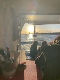 A stunning sunset view from inside a boat, showcasing guests enjoying the scenery — perfect for romantic evenings or group celebrations on the water.
