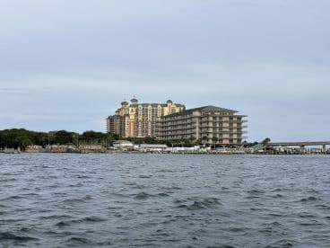A view of a waterfront area featuring a large building and marina, but the focus is unclear.