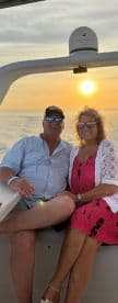 A couple enjoys a romantic sunset moment aboard a yacht, capturing the essence of love and adventure on the open water.