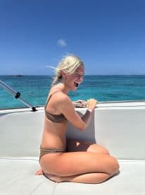 A joyful girl enjoys her time on a boat, capturing the essence of fun and adventure on the open ocean.