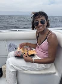 A guest enjoys a selection of snacks on board, showcasing the perfect onboard amenities for a delightful boating experience.