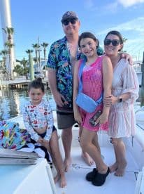 A cheerful family poses together on a boat, capturing a joyful moment on the water — perfect for family outings and memorable adventures.