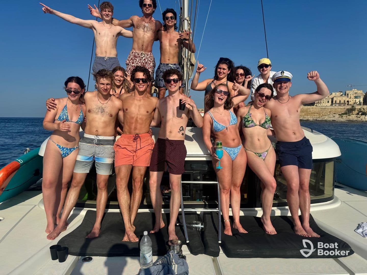 A lively group of friends celebrates aboard a yacht, enjoying the sun and sea — perfect for summer parties and unforgettable memories.