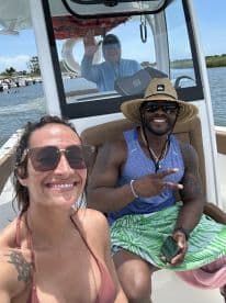 A joyful moment captured on a boat with friends, showcasing smiles and camaraderie on the water — perfect for summer adventures.