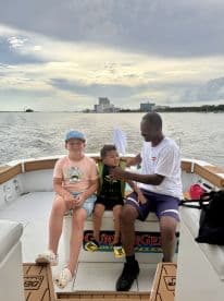 A joyful moment aboard a boat with two children and an adult, capturing the essence of family fun on the water.
