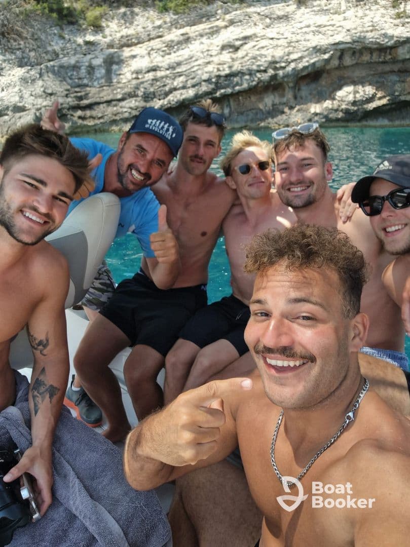 A lively group of friends enjoys a fun day on the water, capturing memories aboard a boat with smiles and camaraderie.