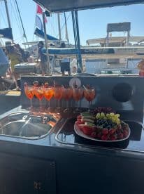 A vibrant display of cocktails and fresh fruit on board, perfect for entertaining guests during a day on the water.