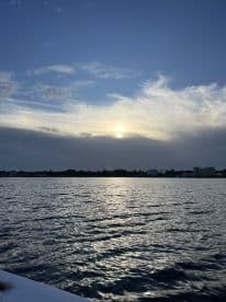 A serene sunset view over calm waters, capturing the tranquil beauty of the evening sky — perfect for peaceful boating experiences.