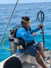 A diver prepares for snorkeling in clear blue waters, showcasing the excitement of underwater exploration and marine adventures.