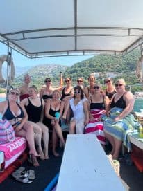 A lively group of women enjoys a fun day on the boat, perfect for celebrations and memorable outings on the water.