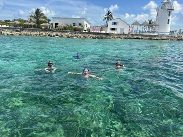 A group of snorkelers enjoys the vibrant underwater scenery in crystal-clear waters, perfect for aquatic adventures and exploration.