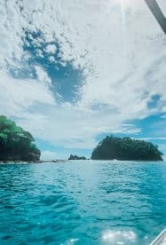 A stunning view of a serene coastline with lush islands and vibrant blue waters, perfect for showcasing the beauty of a tropical getaway.
