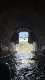 An intriguing view from within a tunnel, looking out towards a scenic landscape. The image captures the unique structure but lacks clarity.