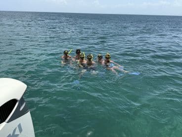 A group of young snorkelers enjoys a fun day in the water, showcasing the excitement of underwater exploration.