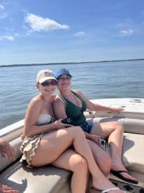 Two friends enjoy a sunny day on a boat, capturing the essence of summer fun and friendship on the water.